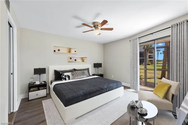 Bedroom featuring access to exterior, wood finished floors, and a ceiling fan