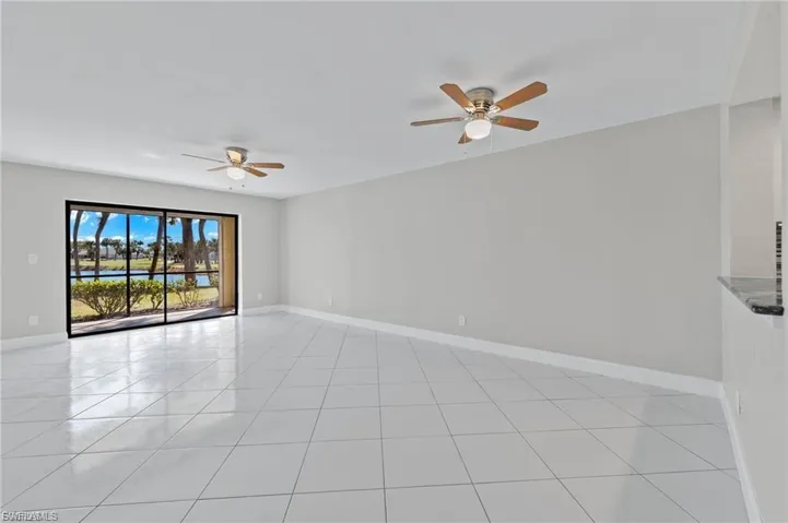 Spare room with ceiling fan and light tile patterned floors