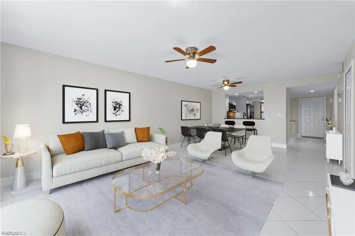 Living room with light tile patterned floors and ceiling fan