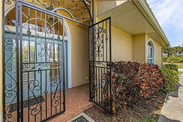 Tiled, double door entry with wrought iron gate.