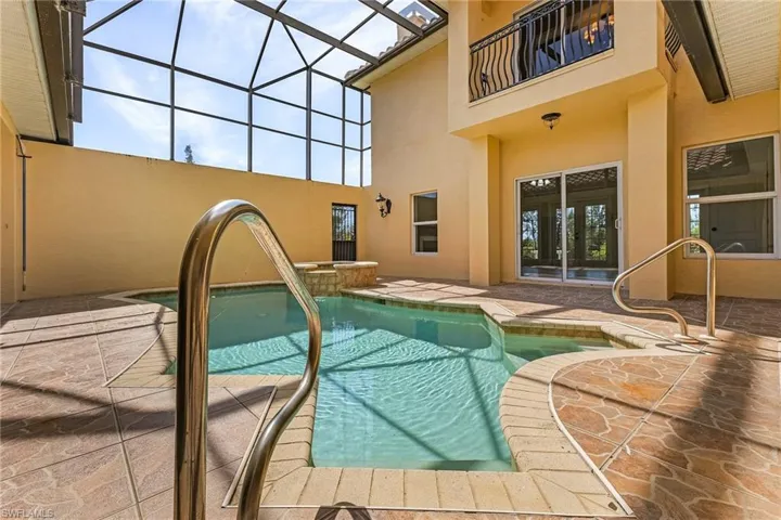 Courtyard area with view of heated, salt system pool featuring a lanai and a patio area
