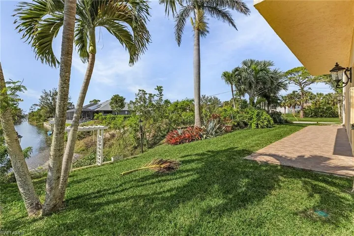 View of yard featuring a water view and a patio