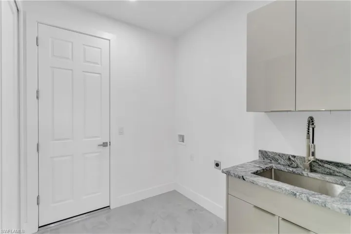 Laundry room featuring washer hookup, cabinets, hookup for an electric dryer, and sink