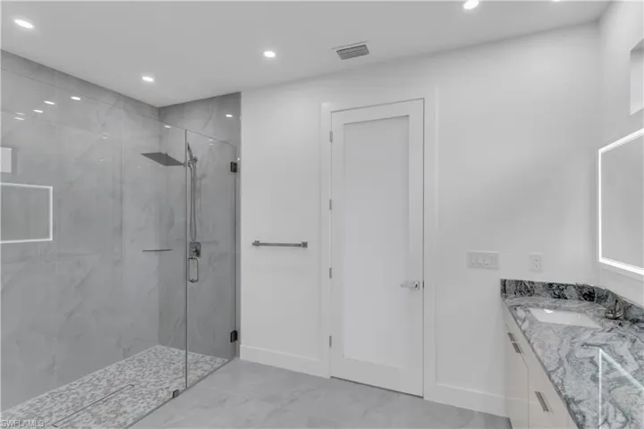 Bathroom with an enclosed shower and vanity