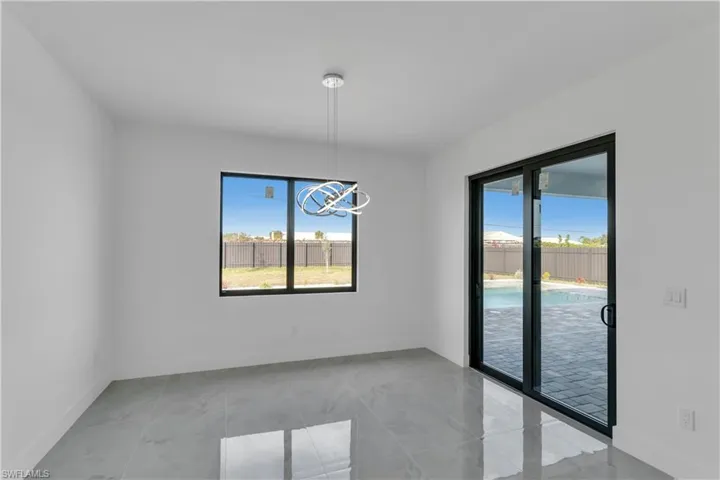 Unfurnished dining area featuring an inviting chandelier and a wealth of natural light