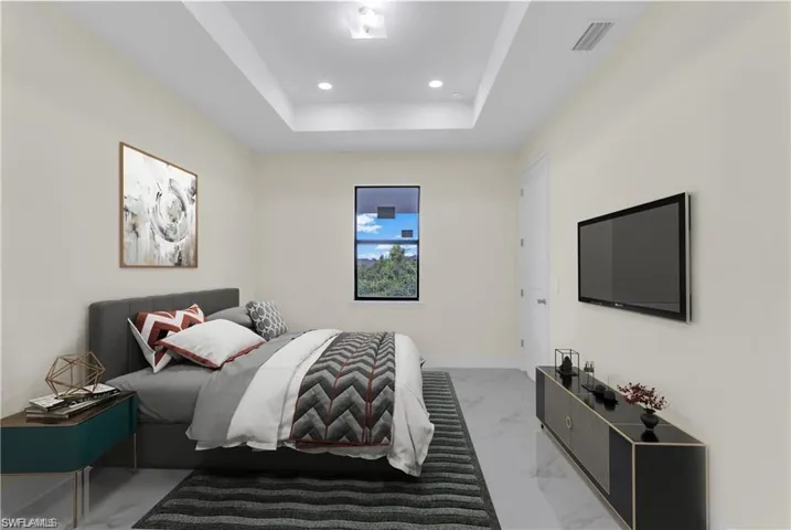 Bedroom with a raised ceiling