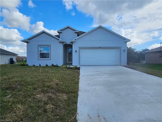 View of front facade with a front yard and a garage