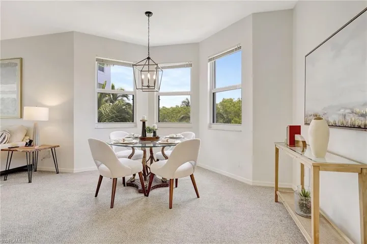 Dining area featuring a chandelier and carpet floors