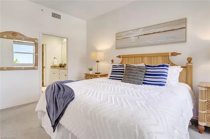 Bedroom featuring carpet flooring and ensuite bathroom