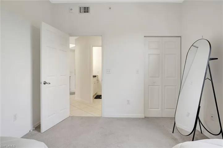 Unfurnished bedroom with a closet and light colored carpet