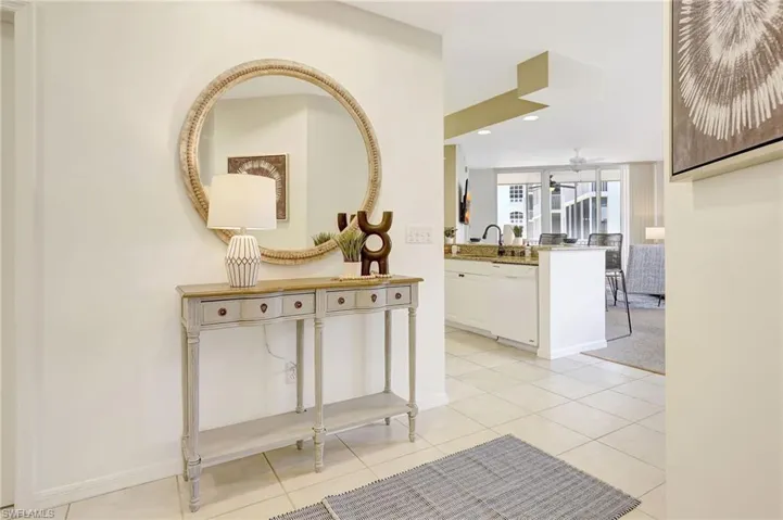 Hallway with light tile patterned flooring and sink