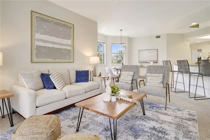 Living room featuring a notable chandelier and carpet