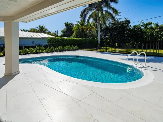 View of swimming pool with a fenced in pool, fence, and a patio area