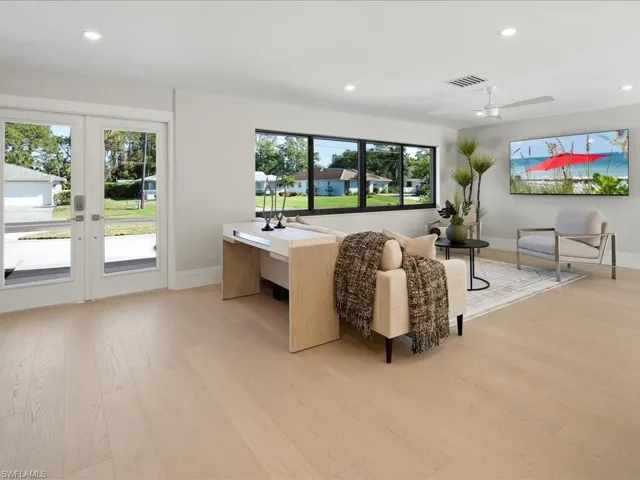 Living area with light wood-type flooring, visible vents, plenty of natural light, and recessed lighting