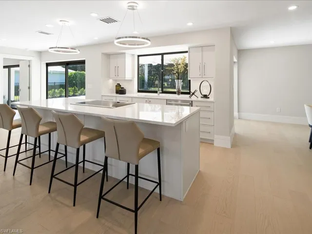 Kitchen with visible vents, backsplash, pendant lighting, light countertops, and black electric cooktop