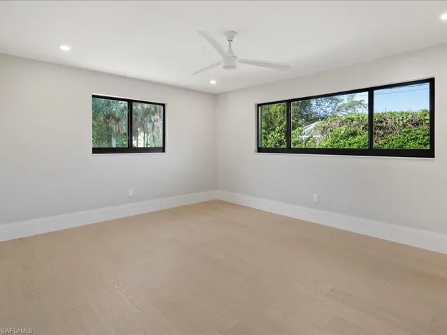 Spare room with recessed lighting, light wood-type flooring, baseboards, and ceiling fan