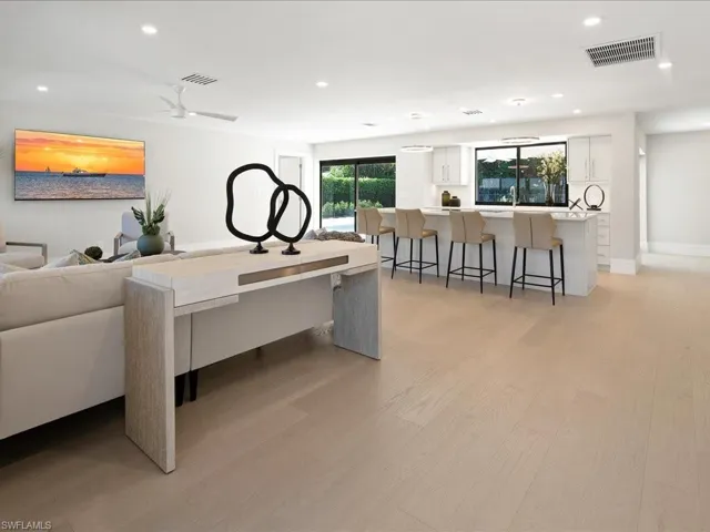 Living area featuring light wood finished floors, visible vents, recessed lighting, and baseboards