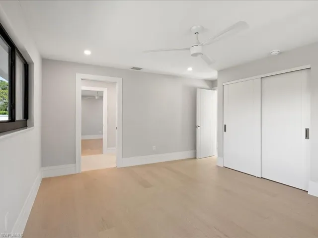 Unfurnished bedroom with visible vents, baseboards, recessed lighting, a closet, and light wood-type flooring