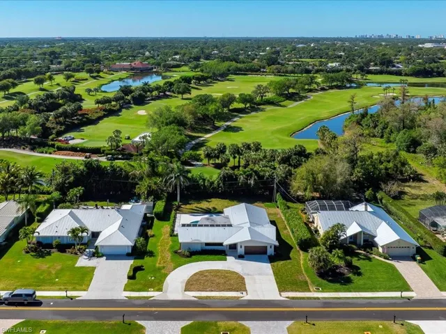 Bird's eye view featuring golf course view and a water view