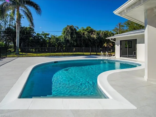 View of swimming pool with a fenced in pool, a patio area, and fence