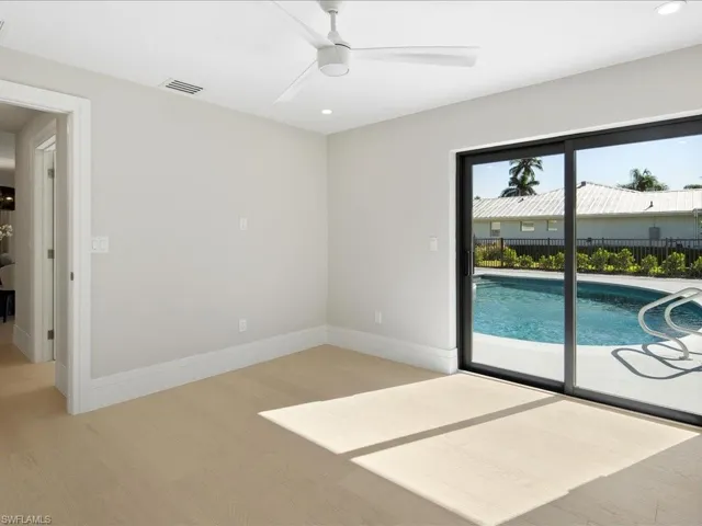 Empty room featuring light wood-type flooring, baseboards, visible vents, and ceiling fan