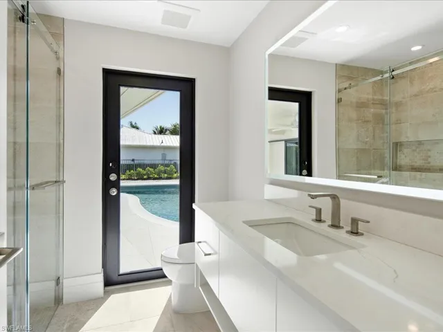 Full bathroom featuring recessed lighting, vanity, toilet, and a shower stall