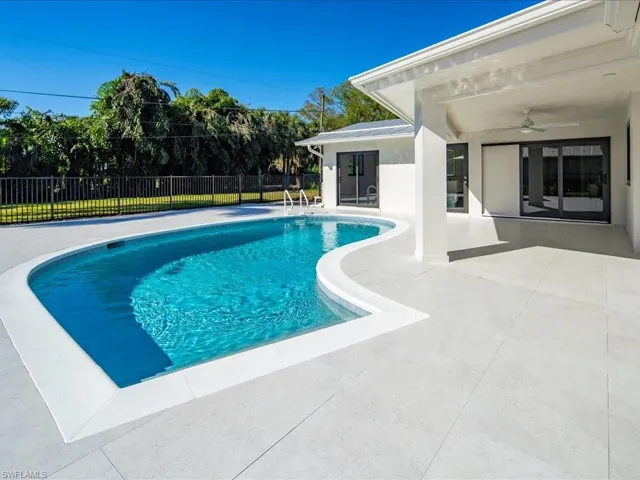 View of swimming pool with a fenced in pool, a patio, ceiling fan, and fence