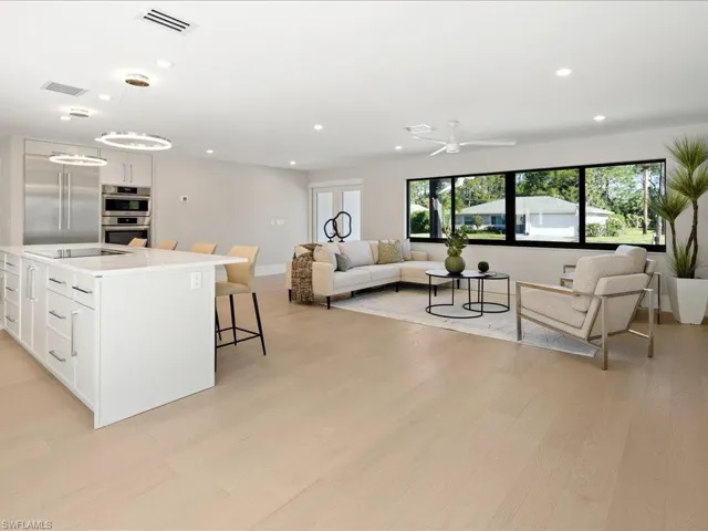 Kitchen with white cabinetry, open floor plan, visible vents, and appliances with stainless steel finishes