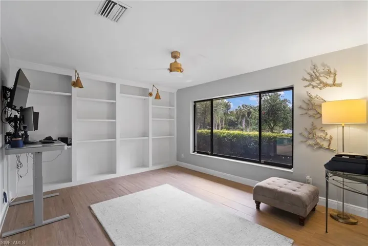 Living area with wood-type flooring and ceiling fan