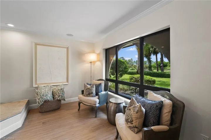 Sitting room featuring crown molding, plenty of natural light, and light hardwood / wood-style floors