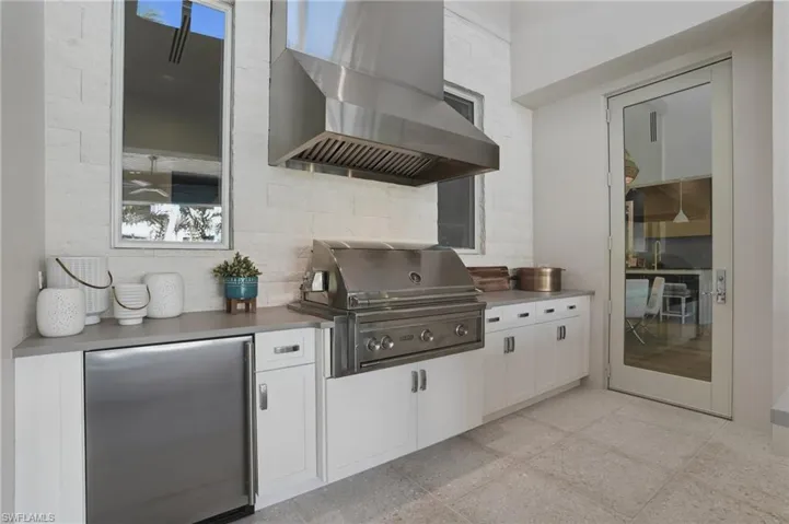 Summer kitchen complete with fridge, gas grill and ice maker