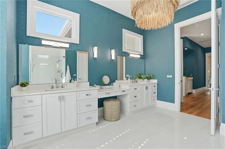 Complete with dual vanities, abundant storage, natural light and designer lighting