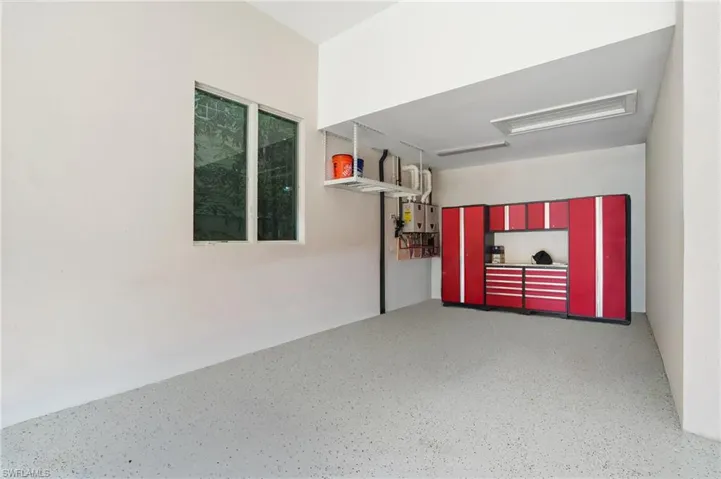 Built-in cabinetry and overhead storage, support an organized garage environment with space for tools and hobbies