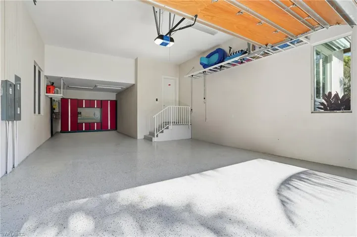 A three-car garage with epoxy flooring, high ceilings, and direct interior access, ideal for daily use and vehicle collection
