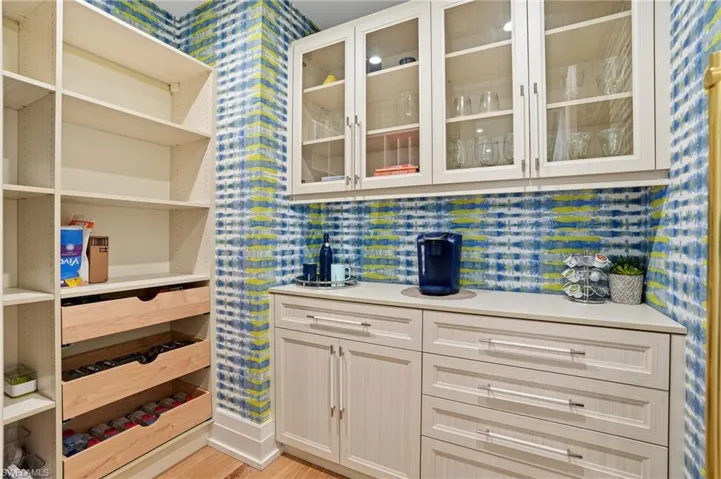 The walk in Butler's Pantry features storage and organization to a chef's delight