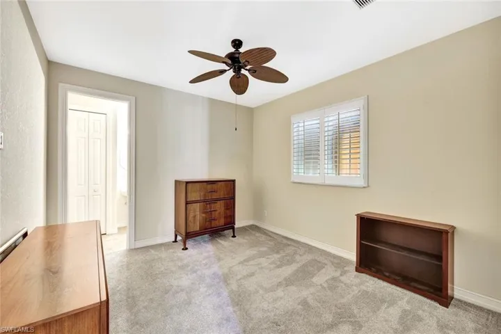 Bedroom featuring baseboards, carpet flooring, and ceiling fan