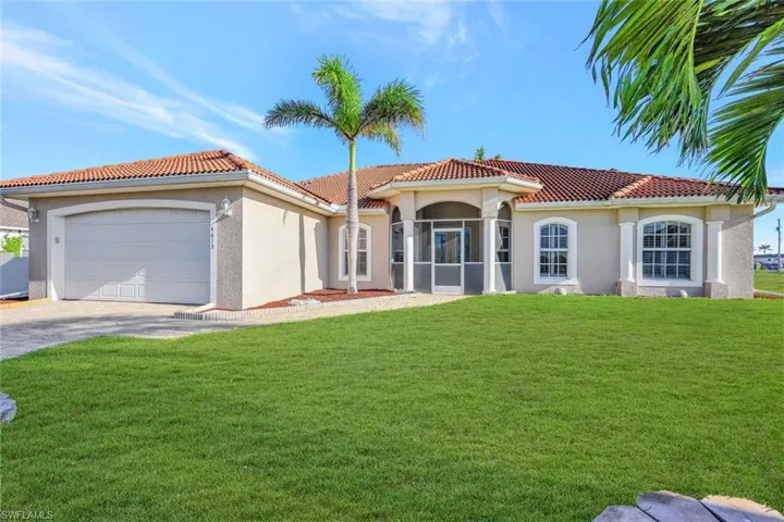 Mediterranean / spanish-style house featuring a front lawn, a tile roof, stucco siding, and an attached garage