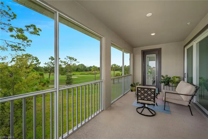 Sunroom / solarium with an east and westerly view of golf course and recessed lighting.