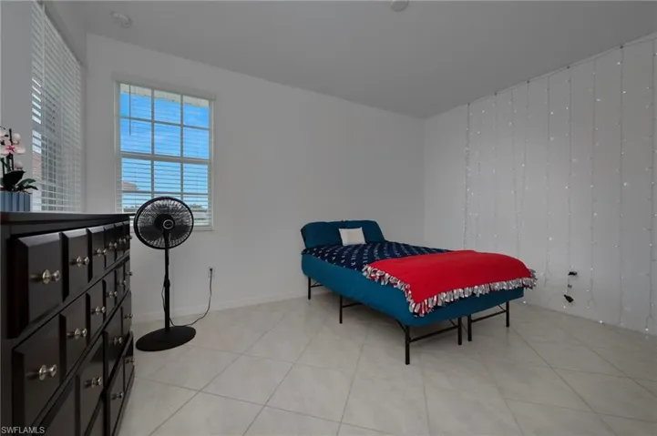 Bedroom with light tile patterned floors and baseboards