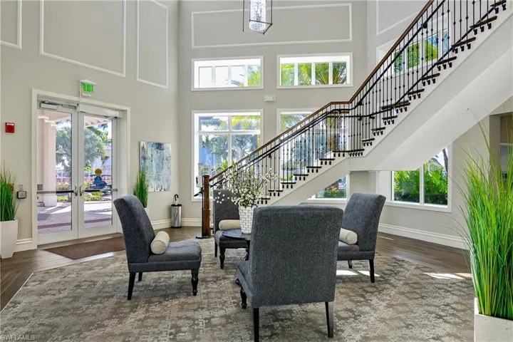 Living room featuring wood-type flooring and a high ceiling