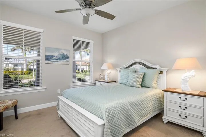 Carpeted bedroom with ceiling fan