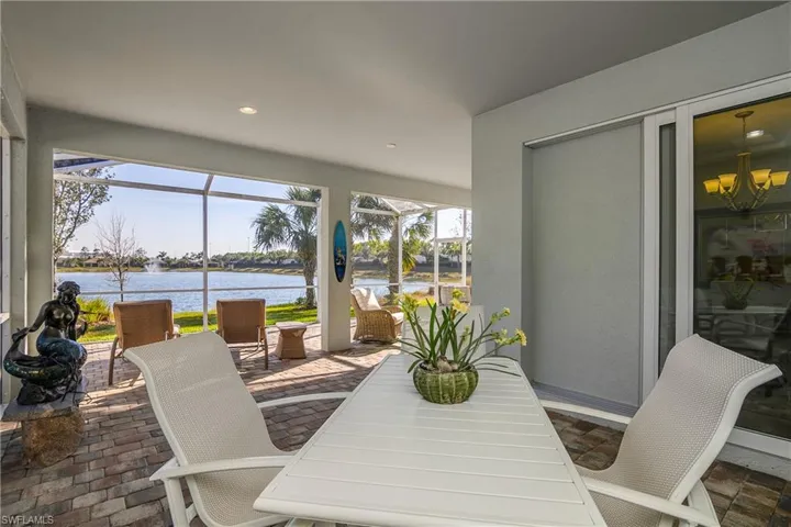 Sunroom with a water view and a chandelier