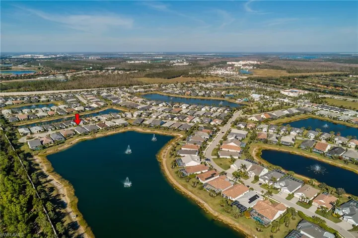 Birds eye view of property with a water view