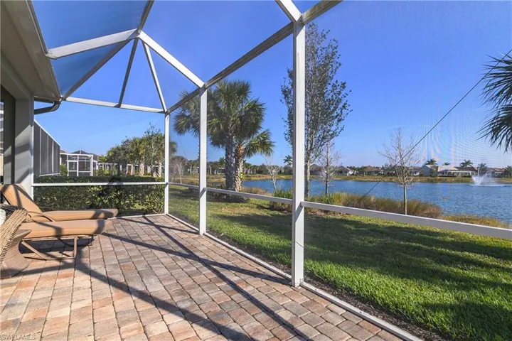 Sunroom / solarium featuring a water view
