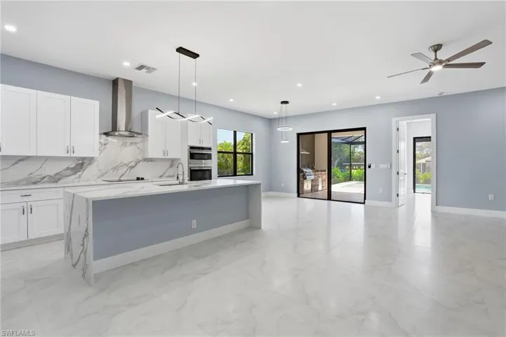 Kitchen with view of lanai and outdoor kitchen