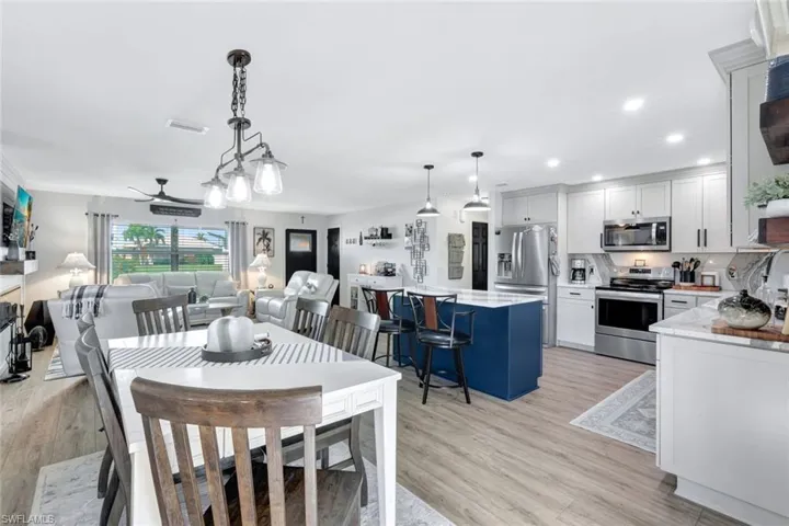 Dining space featuring light wood-style vinyl floors and ceiling fan