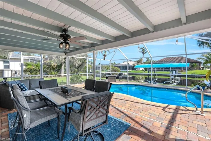 View of pool with a lanai and a patio area