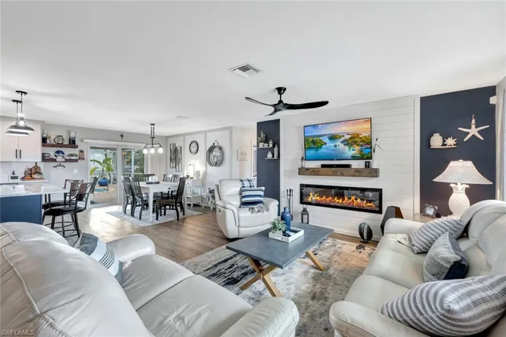 Living room with wood-style vinyl flooring and ceiling fan