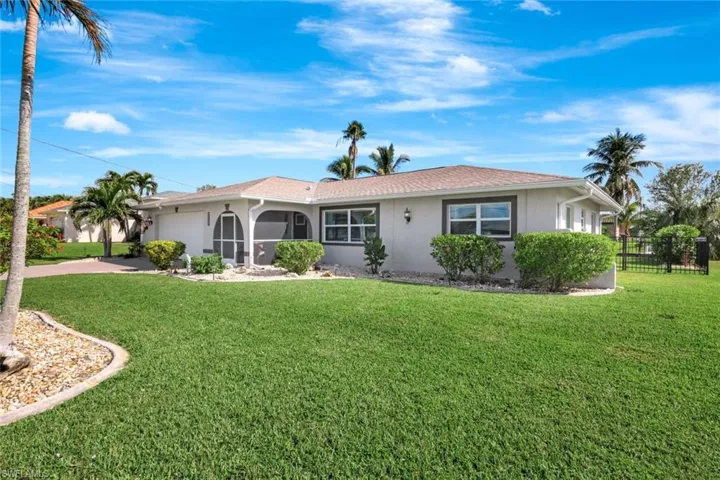 Ranch-style home featuring a garage and a front yard