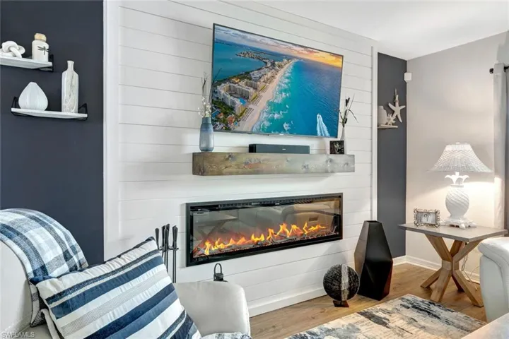 Living area featuring wood-style vinyl floors and a large fireplace